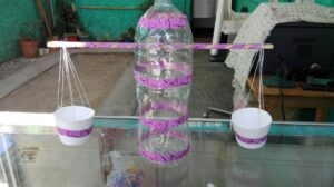 imagen de balanza casera con vasos de colores