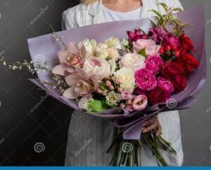 manos sosteniendo un ramo de clavelinas con flores secas